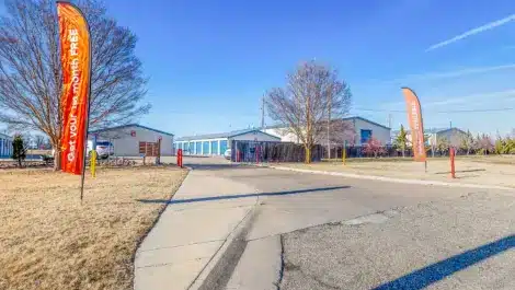 View as you approach the gate of Mini Mall Storage facility in Foxboro Salina
