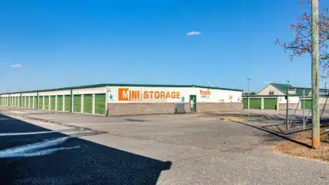Large sign displaying Mini Mall Storage on the side of a storage building
